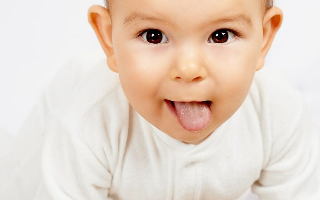 Smiling baby with its tongue out