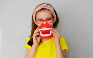 Child with tooth model