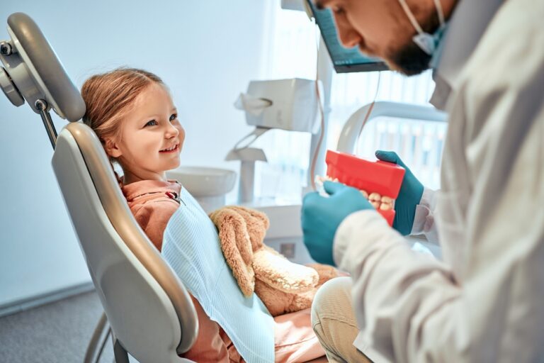 Children's,Dentistry.,A,Little,Girl,Sits,In,A,Dental,Chair
