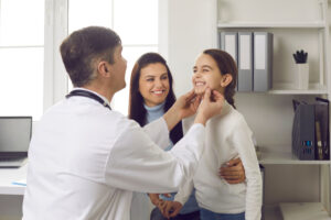 Dentist Examines Little Patient. Happy Smiling Kid Shows Good White Teeth