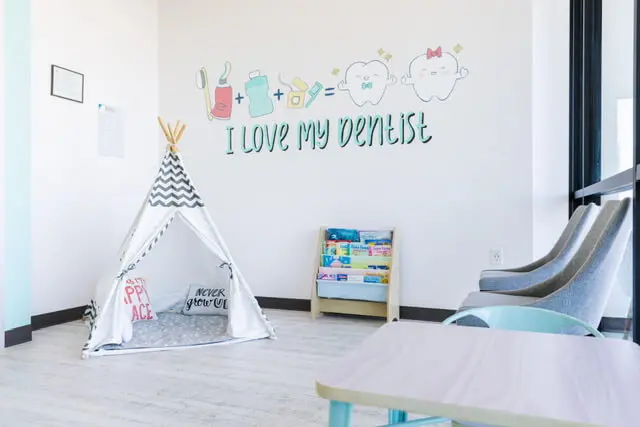 Pediatric dentist examining a child’s teeth during a preventive dental visit in Richmond, TX