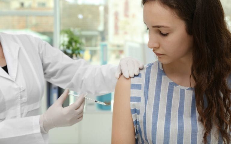 Teen receiving a vaccination